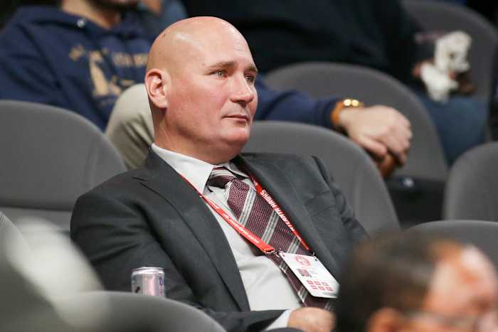 Travis Schlenk watches a game from the stands.